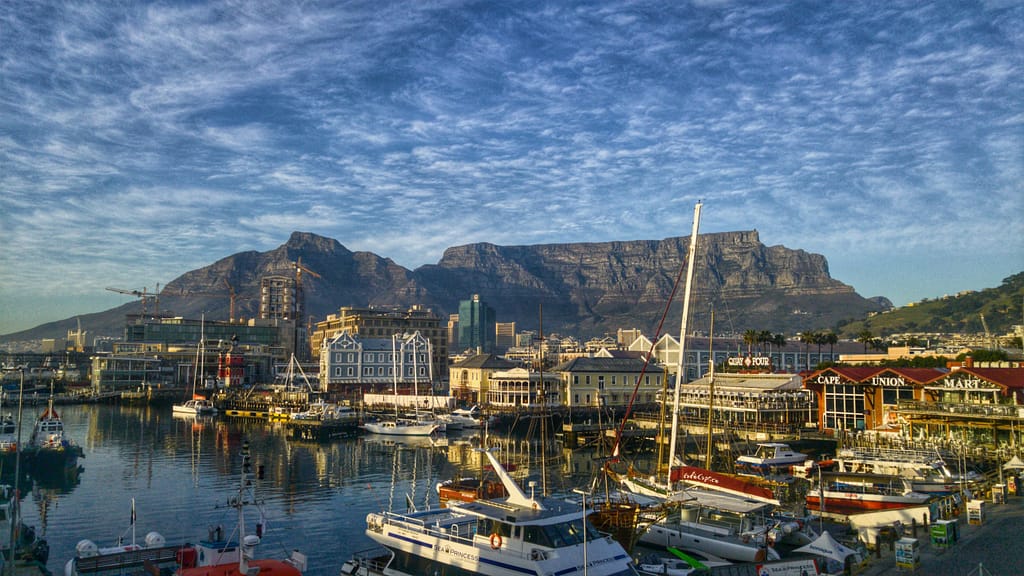 Stunning view of Cape Town harbor with boats and iconic Table Mountain backdrop.