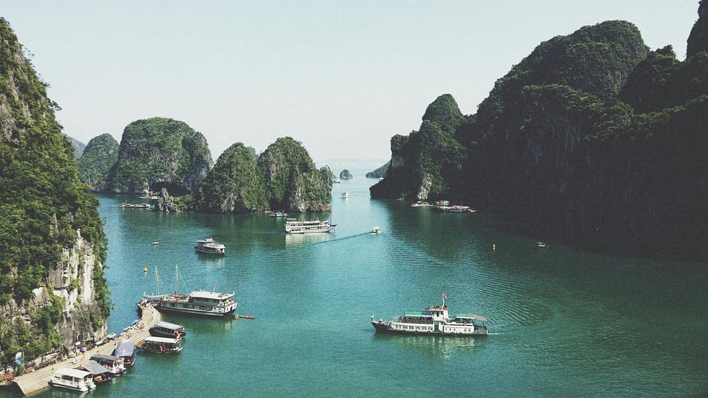 A breathtaking view of Halong Bay with boats navigating through limestone islands.