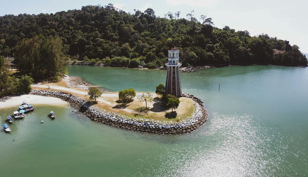 Scenic aerial view of a lighthouse on lush island in Langkawi, Malaysia.