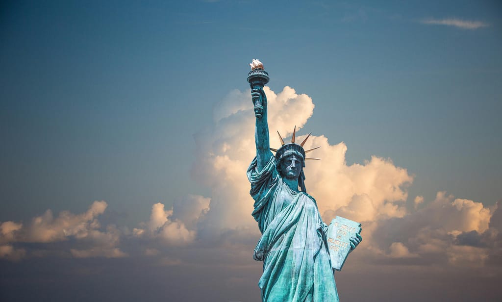 pexels-photo-290386-290386 Iconic Statue of Liberty with majestic clouds in New York, USA. Perfect travel destination image.