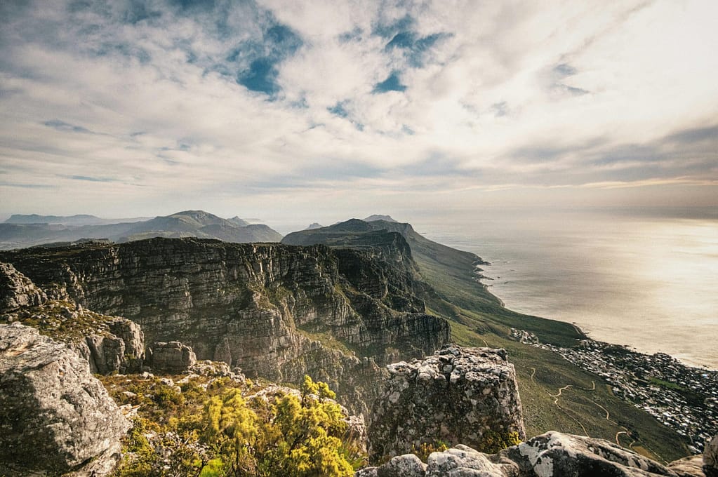 Breathtaking aerial view from Table Mountain, South Africa, highlighting rugged cliffs and vast ocean.
