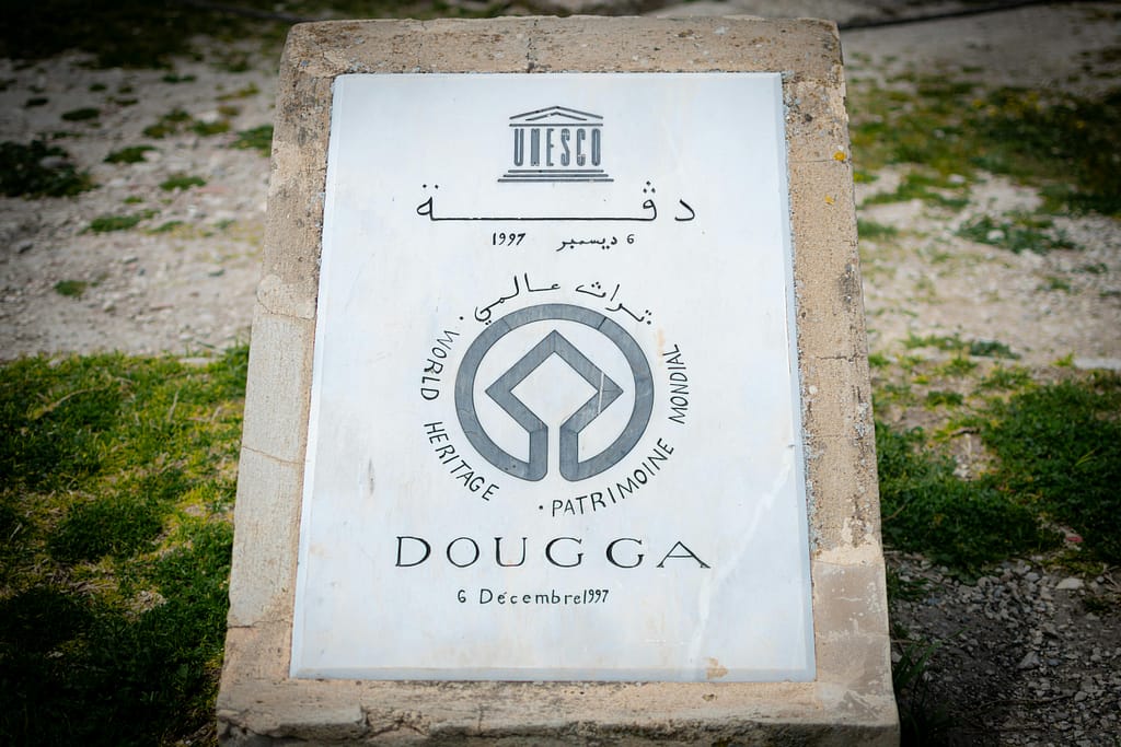 Stone marker designating Dougga as a UNESCO World Heritage Site.