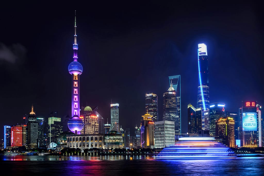 pexels-photo-745243-745243 Stunning night view of Shanghai skyline with illuminated skyscrapers and the Oriental Pearl Tower reflecting in the water.