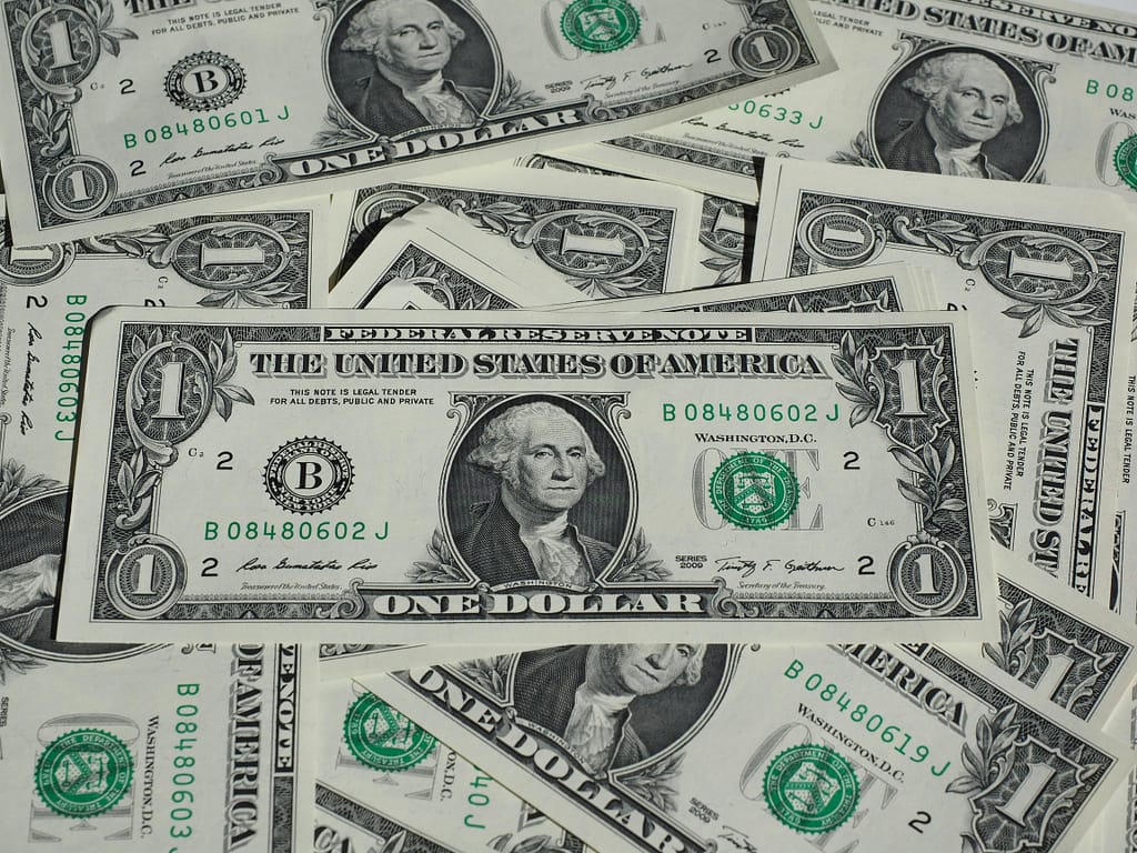 A detailed shot of a pile of U.S. one-dollar bills showcasing currency and finance concepts.