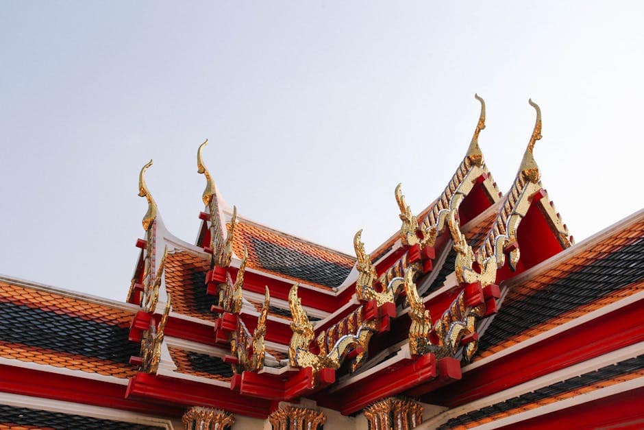 pexels-photo-29155235-29155235 Captivating view of traditional Thai temple roof with ornate details in Bangkok, Thailand.