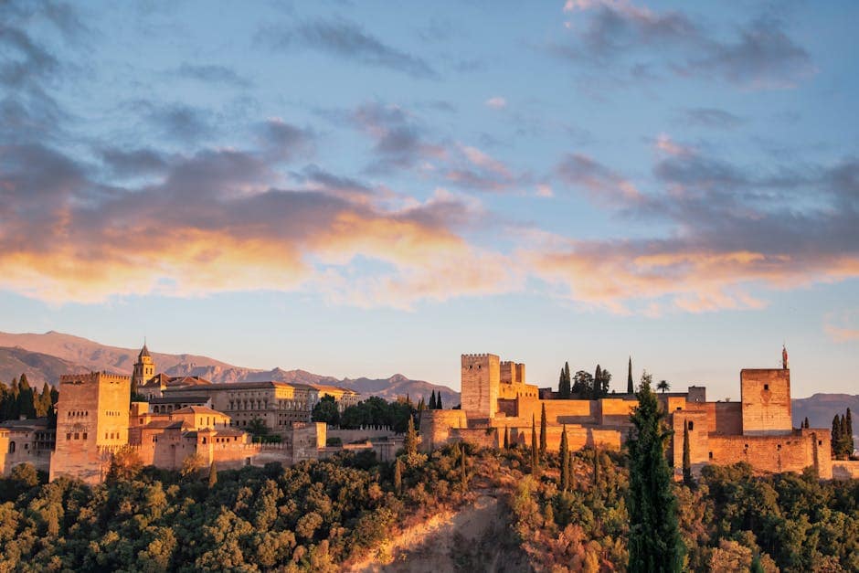 Stunning view of Alhambra Palace during sunrise in Granada, Spain.